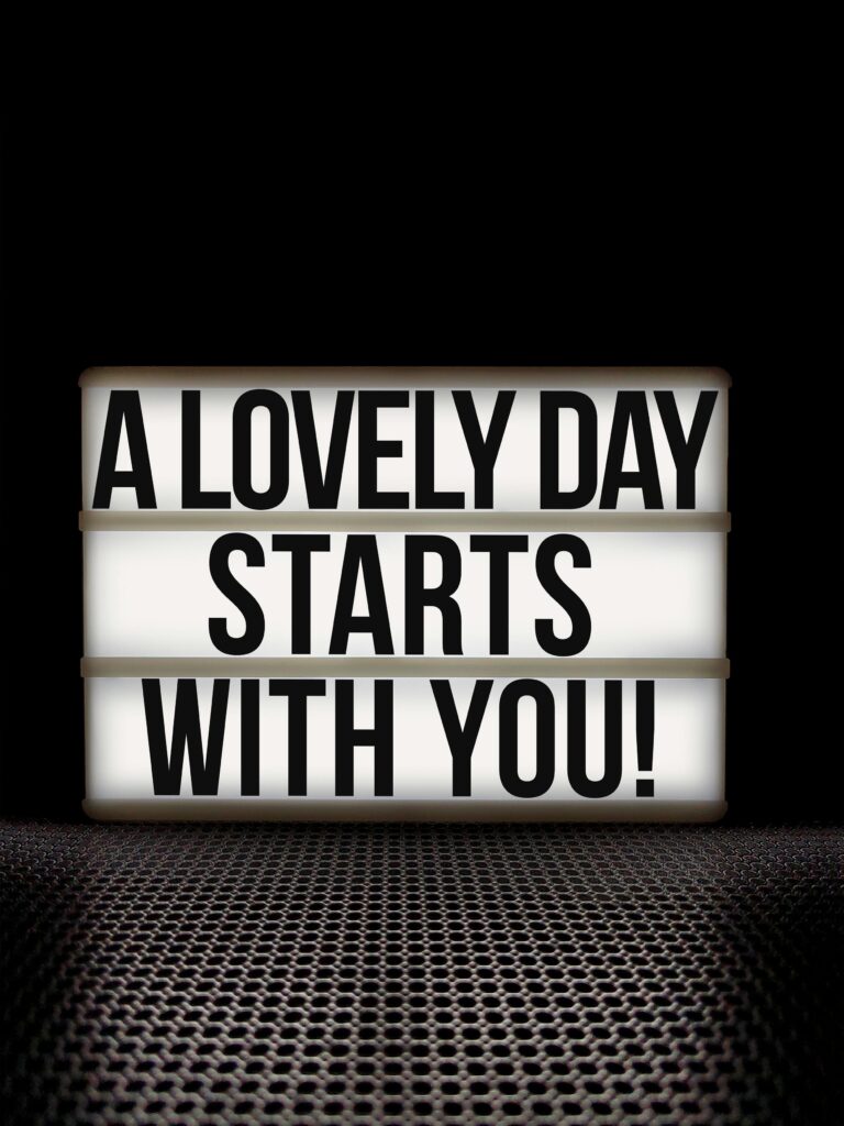 A motivational message on a lightbox against a black background, promoting positivity and empowerment.